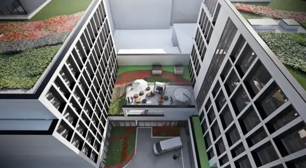 Nowoczesny budynek z zielonymi tarasami i patio, gdzie można odpocząć. To wizualizacja hotelu Meininger Kraków.